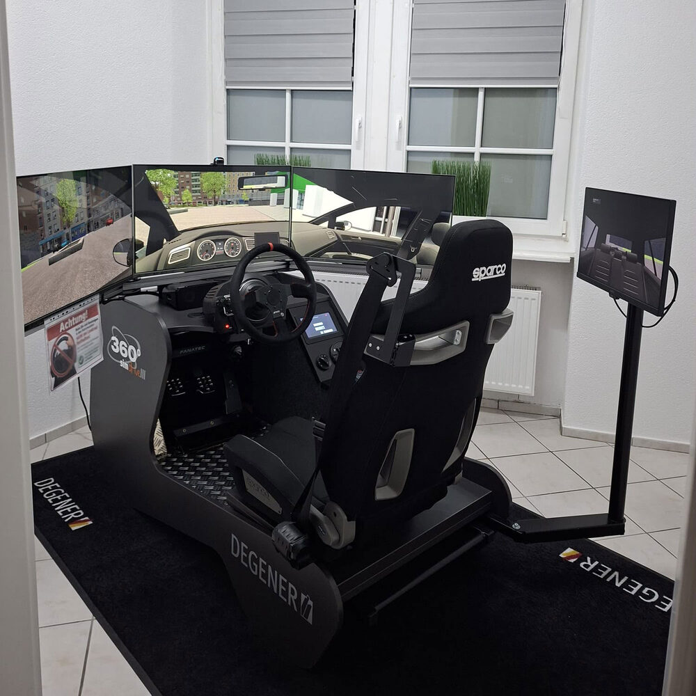 Der Degener-Simulator in Waibstadt: Sportsitz, Lenkrad, drei Bildschirme vorn und ein vierter für den Blick nach hinten